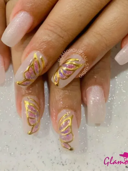 Let your nails take flight with these ethereal butterfly-wing nails. We used 3D gold detailing to outline the wings, which are filled with a beautiful pink glitter. This design is pure magic on your fingertips.