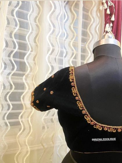 The back view of the black velvet blouse, showing the elegant zardosi work along the border.