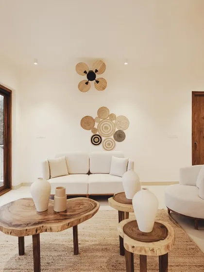 A cozy seating area featuring live-edge wood tables and woven wall decor, demonstrating my commitment to using organic materials and artisanal details.