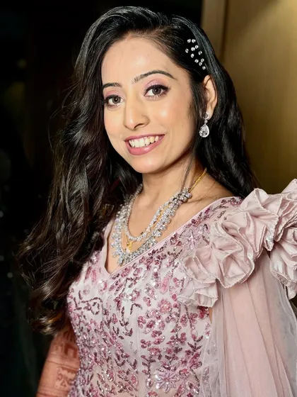 A close-up of this stunning reception bride. Her dewy glam is fresh and modern, with a pop of shimmer on the eyes and a natural pink lip.