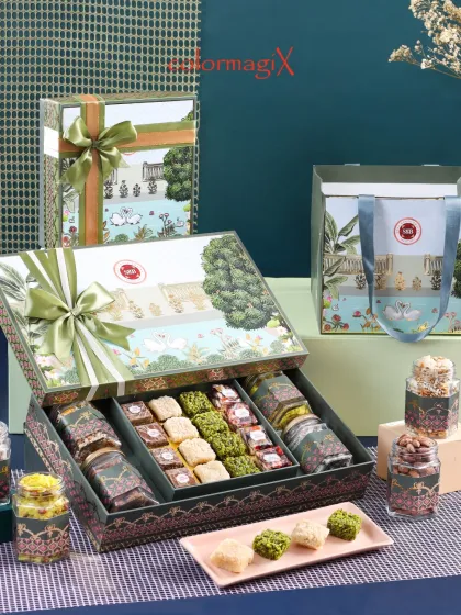Our green designer box is a masterpiece of festive packaging. Inside, you will find a curated selection of assorted Indian sweets and premium dry fruits, presented in beautifully coordinated jars.