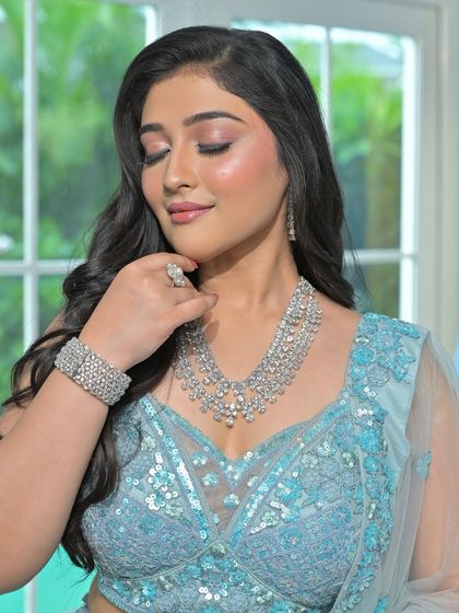 A serene and beautiful shot showcasing the sparkle of the diamond-look jewellery against the cool tones of the blue lehenga.