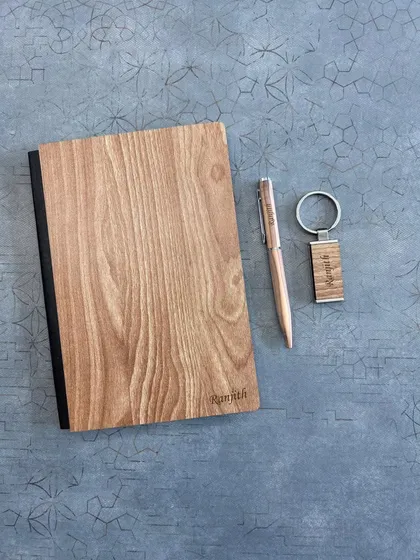 This simple yet elegant set features a light-wood diary and keychain personalized for "Ramith", along with a matching pen. It's a great example of a minimalist and personal wooden gift.