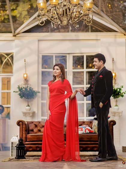 An elegant, full-length shot of the couple. The makeup is glamorous and sophisticated, fitting for a grand 25th-anniversary celebration.