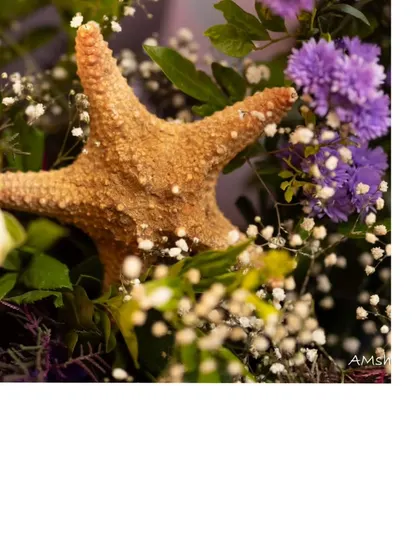Even the floral arrangements included themed elements like this starfish, blending natural beauty with the magical underwater concept.