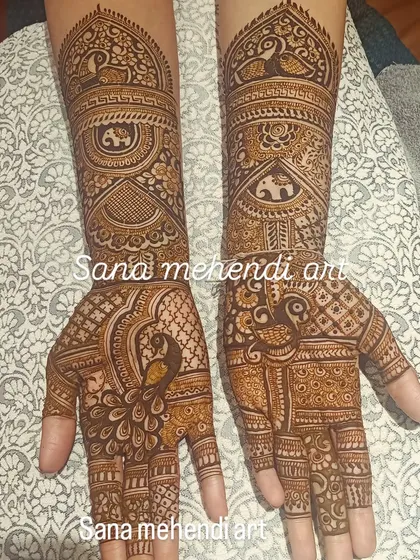 An intricate design featuring majestic peacocks on the palms and rows of elephants on the arms, perfect for a traditional bride.