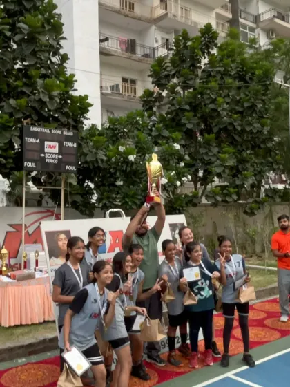Lifting the trophy high. Our U-14 girls' team celebrating their championship win, a proud moment for the players, coaches, and parents.