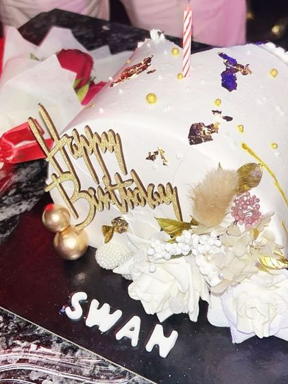 A candid shot from a client's gallery, showing my swan cake ready to be enjoyed at a celebration.