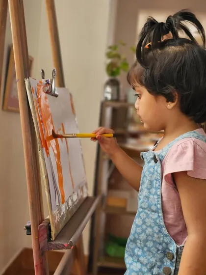 We nurture the artist in every child. At our easels, little hands are free to explore colors and express their creativity, developing focus and fine motor skills through process-based art.