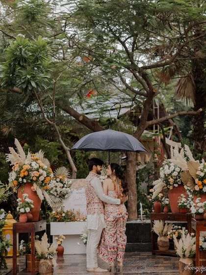 A romantic moment under an umbrella during a rainy day shoot in Udaipur. The weather just added to the cozy, intimate vibe.
