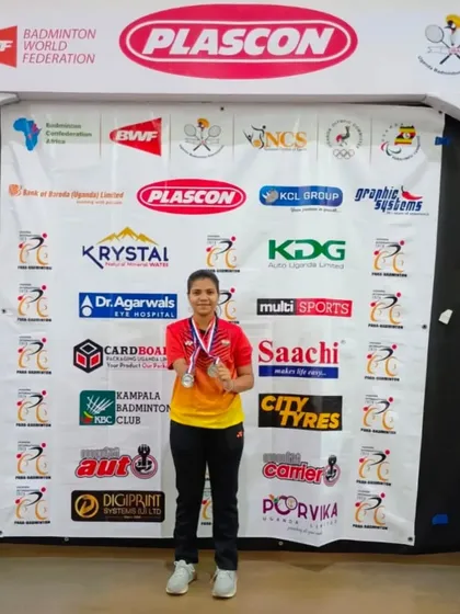 **Double Silver in Uganda.** Our para-athlete Latika proudly displays her two silver medals from the Uganda Para Badminton Tournament 2024, competing in both Women's Singles and Women's Doubles.