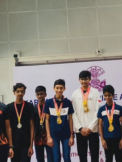 A group of our decorated rifle shooters after the medal ceremony at the Karnataka State Competition, showcasing their individual and team medals.