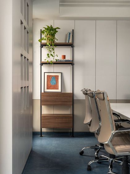 The conference room's design incorporates functional storage and display shelving, ensuring the space is both beautiful and practical.