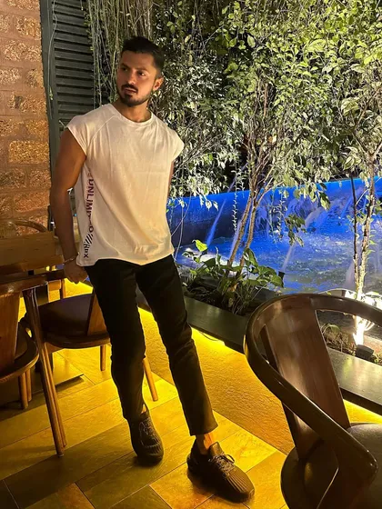 A stylish night-out look. A simple white tee and black pants can be elevated with the right attitude.