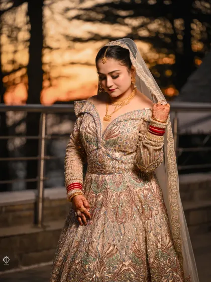 A bride at dusk, with the warm sunset glow behind the pine trees. I use the natural light of the mountains to create portraits that are soft, romantic, and full of atmosphere.