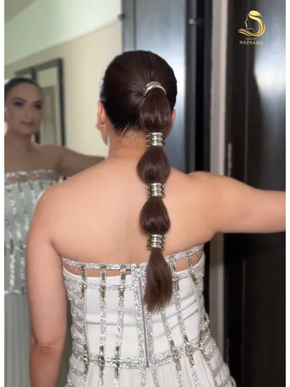 The finished bubble braid, looking sharp and chic. It’s a fantastic option for anyone wanting a modern yet elegant hairstyle for a party.
