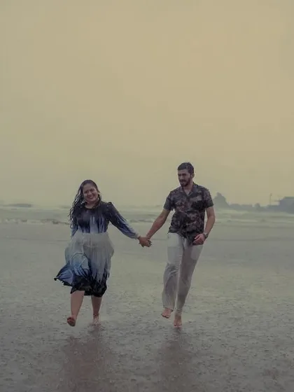 Hand-in-hand, running through the rain. This candid shot from a monsoon pre-wedding in Goa is all about capturing the energy and spontaneity of the moment.
