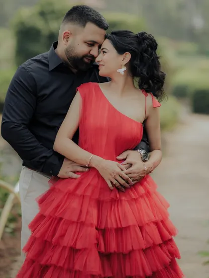 A close-up shot capturing the loving gaze between the couple. The woman's hand gently touching his face adds to the intimacy of this beautiful moment from their outdoor engagement shoot.