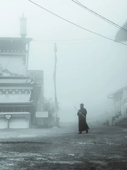 a monk walking through a foggy landscape. this image captures a sense of minimalism and focus, two principles that are core to my design philosophy.