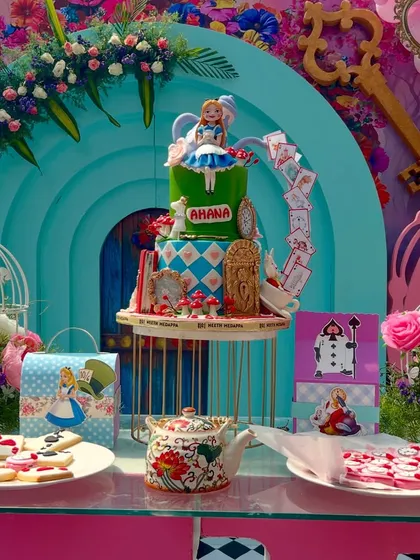 The dessert table was a centerpiece of its own, featuring an incredible tiered cake with Alice characters, themed cookies, and other sweet treats that looked like they came straight from the Mad Hatter's tea party.