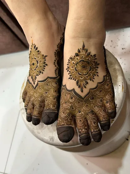 A close-up of the mandala foot design, highlighting the beautiful symmetry and the dark, rich paste.