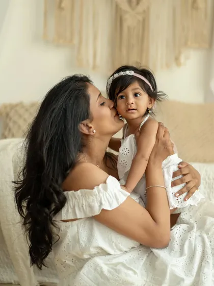 A mother's kiss for her daughter. A simple, beautiful expression of love.