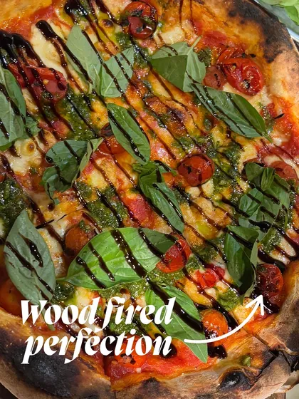 This is what I call wood-fired perfection. A beautifully charred crust, melted cheese, and fresh toppings coming together for the perfect bite.