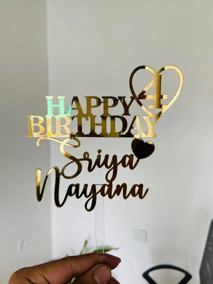This "Happy Birthday Sriya Naydna" topper includes the number 4 within a heart, a creative way to personalize a fourth birthday celebration.