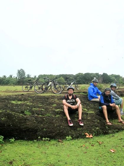 Taking a break on a rocky outcrop amidst the green fields of Gokarna. Our tours are about enjoying the journey and the company of fellow riders.