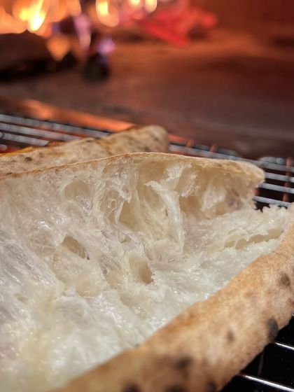Another angle on our airy crust, showing the beautiful contrast between the soft interior and the charred exterior.