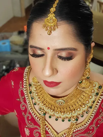 A happy bride is the most beautiful bride. Here, I created a soft smokey eye with a classic red lip, a combination that never goes out of style for Indian weddings.