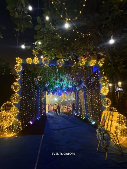 The entrance to Jay and Jinal's Sangeet set the tone for a night of glamour. A tunnel of fairy lights and disco balls created a dazzling welcome, leading guests down a royal blue carpet into the party.