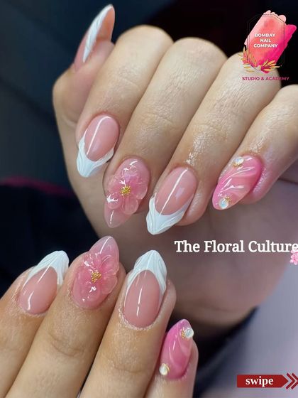 A beautiful example of combining different textures. This set features a white V-French tip, a pink marble accent nail, and stunning 3D pink flowers with gold centers for a truly festive and dimensional look.