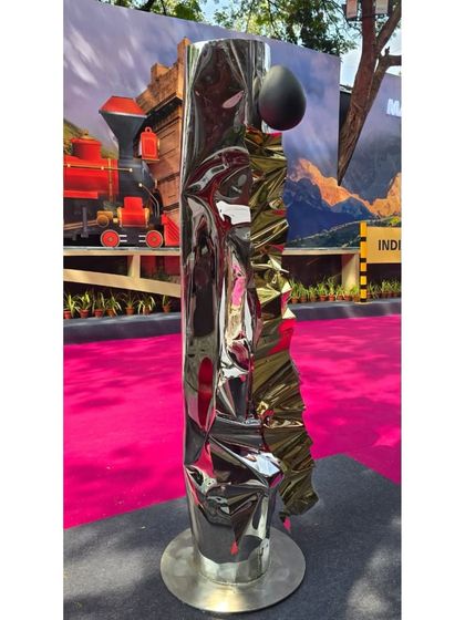 "Eternal Grace," a freestanding sculpture in mirror-polished stainless steel that reflects the strength and sensitivity of womanhood.