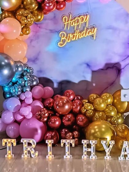 A closer look at the unique marbled backdrop and multi-colored metallic balloon arrangement.