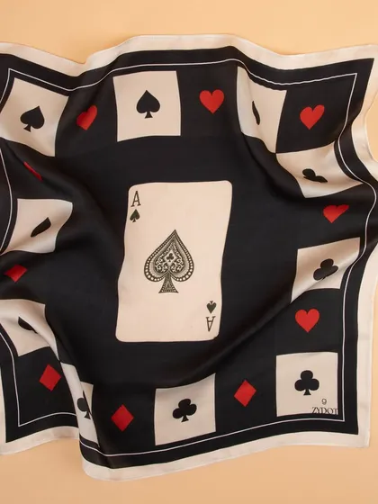 The ace of spades pocket square gently draped to show the soft, flowing quality of the silk fabric.