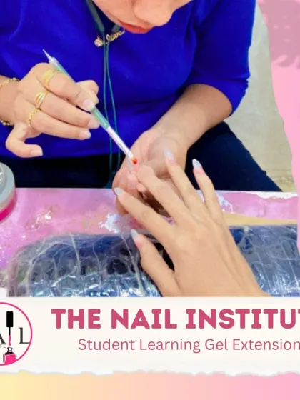 A student learns to apply a bead of gel during a gel extension training session, focusing on control and placement.