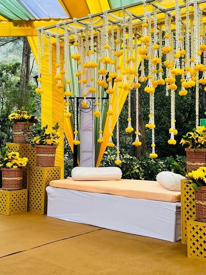 A side view of the Haldi seating, showing the tiered arrangement of sunflower baskets and the intricate lattice-work props.