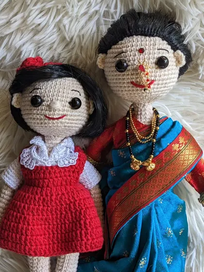 A beautiful custom set featuring a mother and daughter. The doll in the red dress was made to resemble the client's 'jija' (sister-in-law).