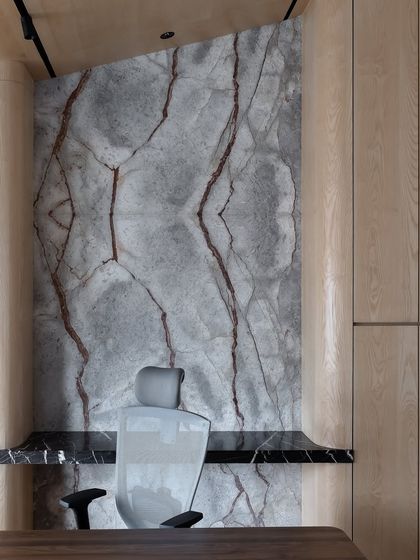 A different perspective of the book-matched marble wall, highlighting its dramatic, symmetrical veining that acts as a natural work of art.