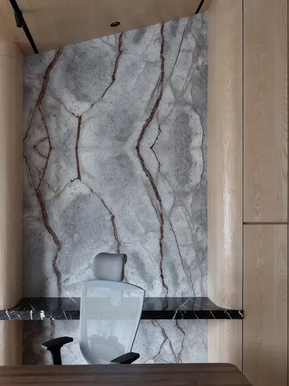 A different perspective of the book-matched marble wall, highlighting its dramatic, symmetrical veining that acts as a natural work of art.