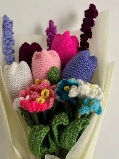 A beautiful handmade bouquet that will never wilt. This arrangement features a mix of colorful tulips, delicate forget-me-nots, and lavender, all crocheted by hand and wrapped beautifully, making it a perfect everlasting gift.
