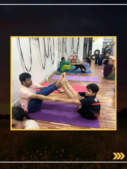 A father and son practicing the partner boat pose together, showing that yoga is a wonderful activity for family bonding.