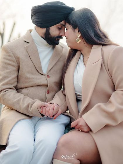 An intimate portrait from a pre-wedding shoot in the beautiful landscapes of Kashmir. The couple's coordinated coats add a touch of winter elegance.