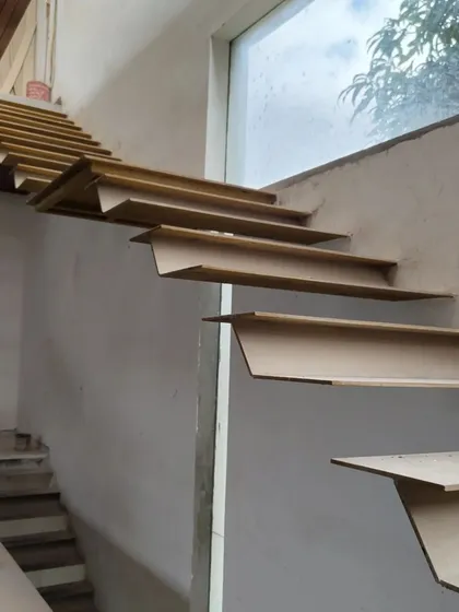 A duplicate of image 124, this photo shows the bare metal treads of a cantilevered staircase during construction, offering a glimpse into the anatomy of our signature floating stair designs.