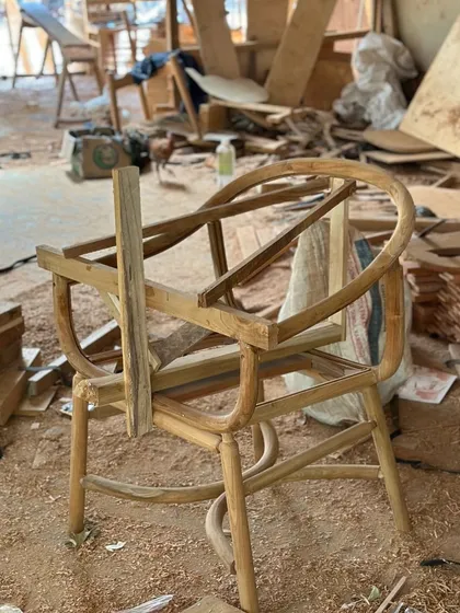 The raw frame of a chair in the middle of my workshop, surrounded by wood shavings and tools. This is where the design first takes physical form.