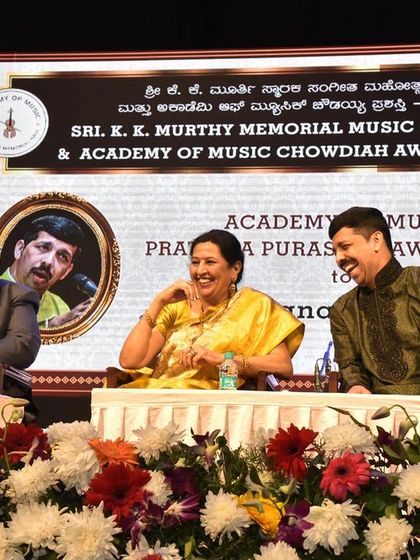 Sharing a laugh on stage during the Chowdaiah National Award ceremony. Even formal events can have moments of lighthearted joy.