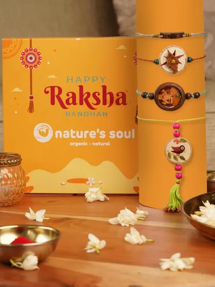 A festive Raksha Bandhan gift box, styled with beautiful, eco-friendly rakhis and traditional elements like jasmine flowers.