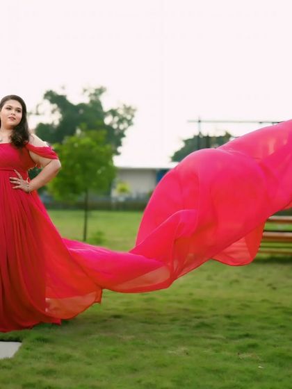 This hot pink infinity gown with a dramatic trail is designed to make you stand out. The bold color and flowing fabric create a vibrant and energetic feel for any photoshoot.