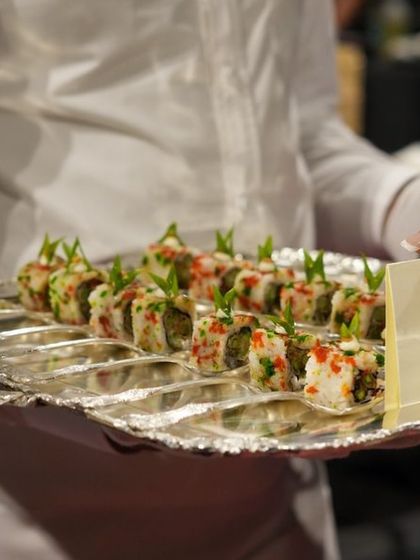 Our Asparagus Tempura Sushi Rolls, elegantly presented on a silver platter by our service staff. This demonstrates our versatility in offering sophisticated global cuisine for corporate canapé service.